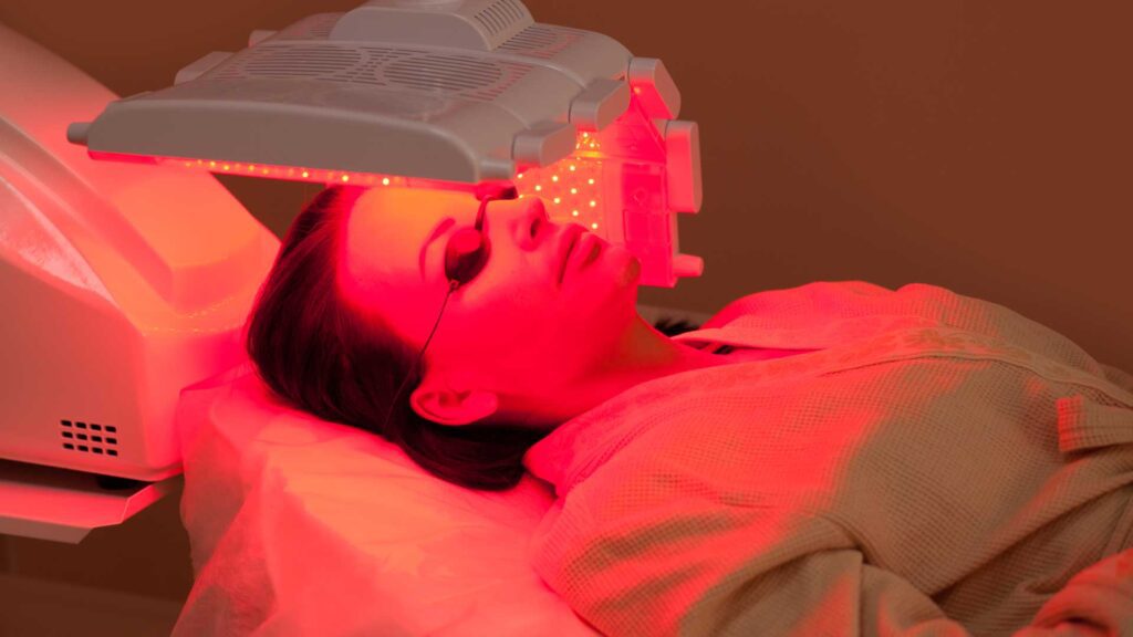 Woman lying on a table skin treatment in spa salon.