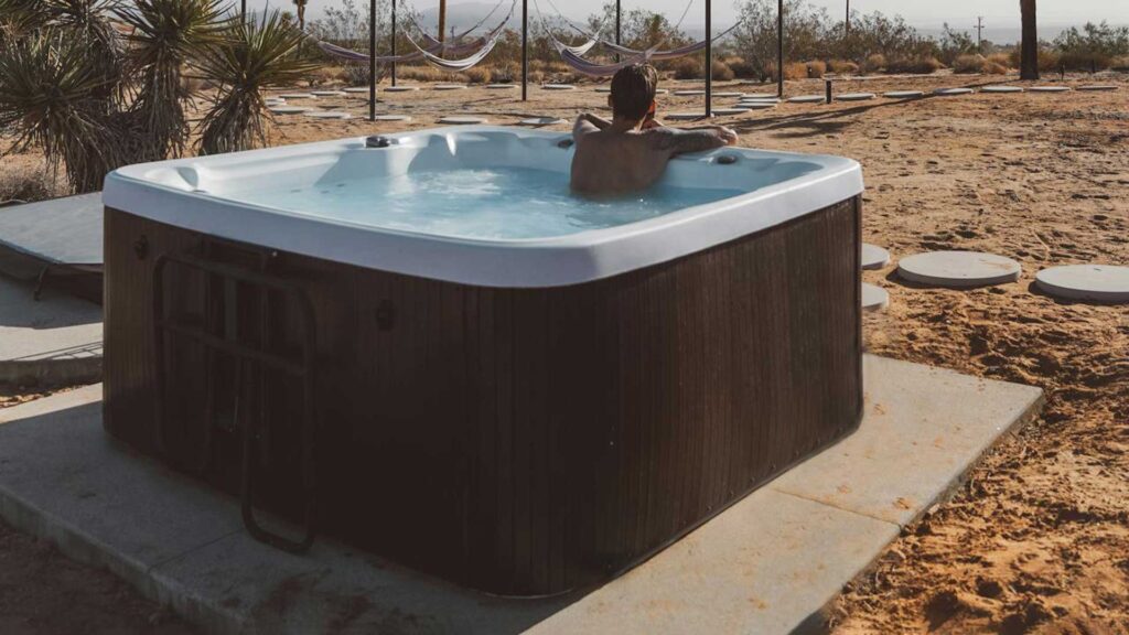 man relaxing hot tub in outside.