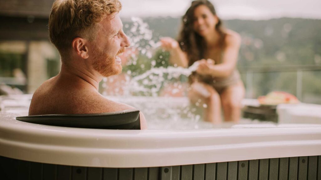 couple enjoying in hot tub.