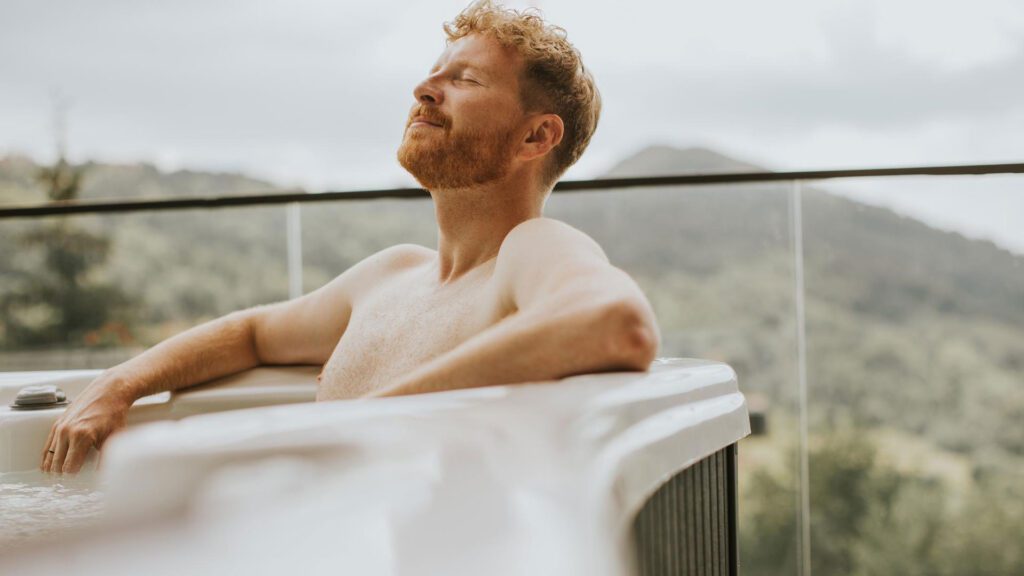 Man soaking in a hot tub